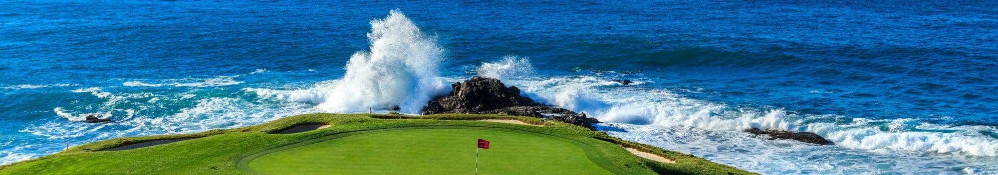 The 7th green at Pebble Beach, with the Pacific breaking on the rocks behind it.