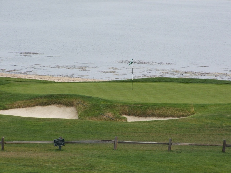 A green at the water's edge.
